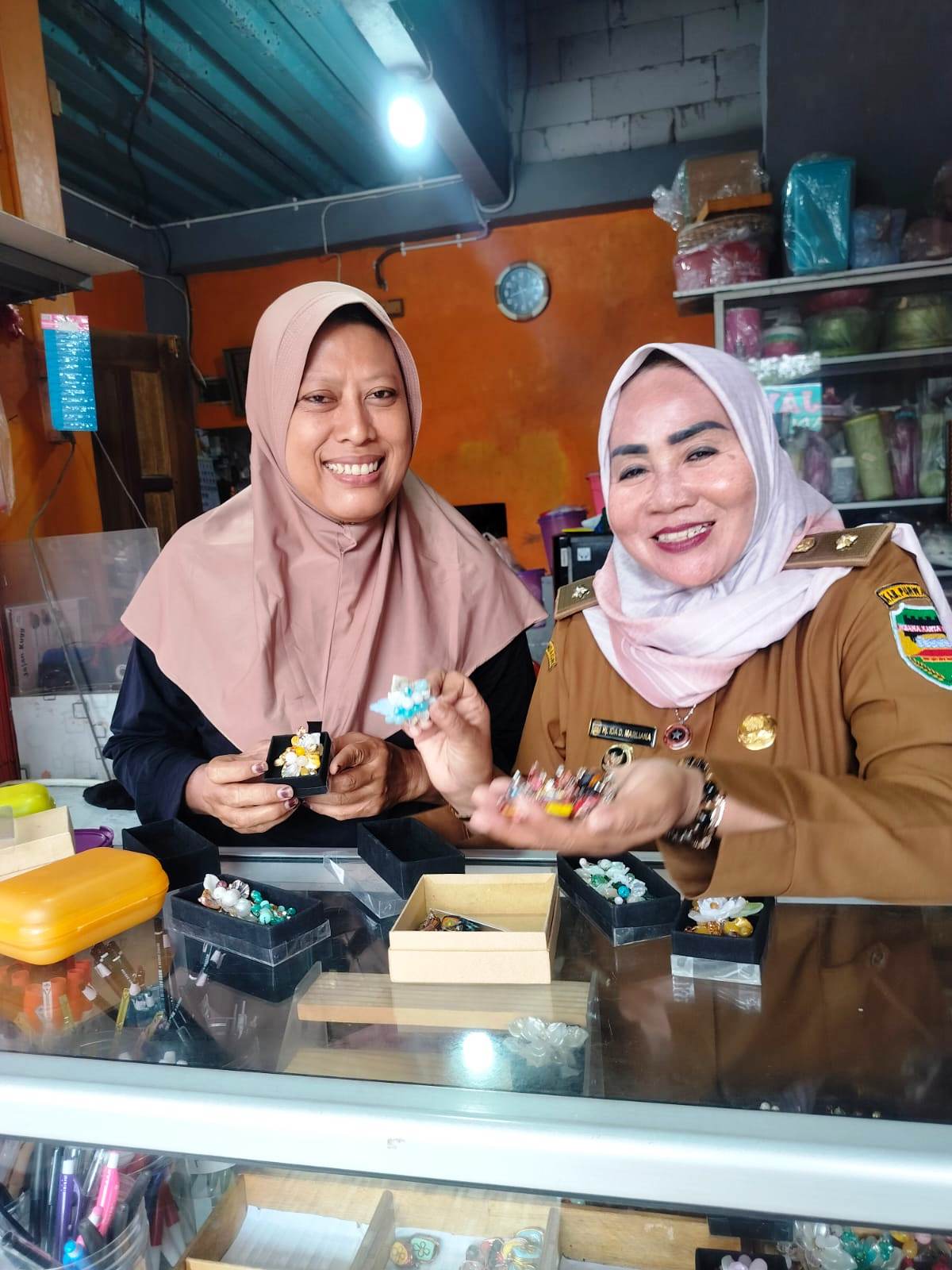 Kepala Desa Cinangka, Ida D Marliana, menunjukan Bros hasil kerajinan UMKM warga Cinangka